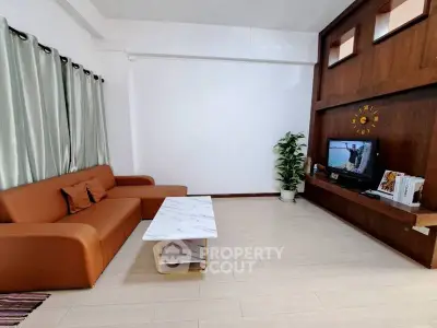 Spacious living room with modern sofa and entertainment center