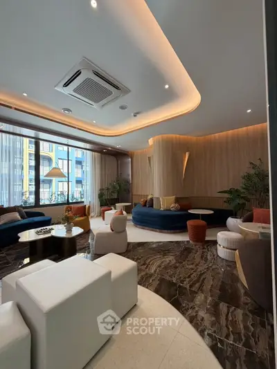 Luxurious modern living room with elegant decor and large windows offering natural light.