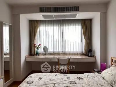Cozy bedroom with large window, elegant curtains, and stylish decor, perfect for relaxation and comfort.