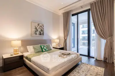 Luxurious bedroom with elegant decor and balcony access in a modern apartment.