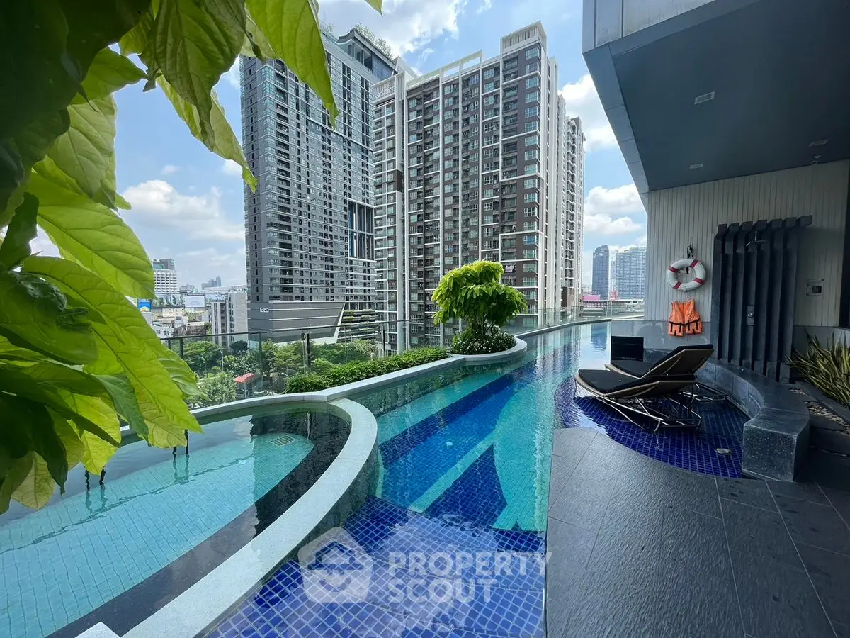 Luxurious rooftop pool with stunning city view and modern lounge chairs.