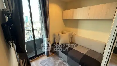 Cozy small bedroom with balcony view in modern apartment