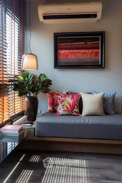 Chic living room with modern decor, stylish cushions, and natural light.