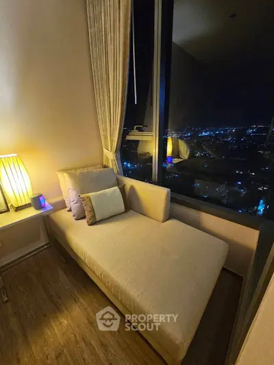 Luxurious bedroom with stunning night city view and elegant chaise lounge