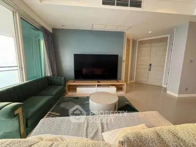 Modern living room with stylish furniture and large TV, featuring a cozy ambiance and elegant design.