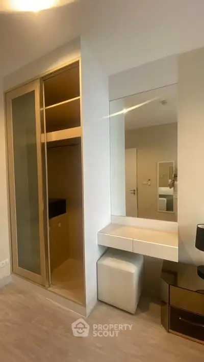 Modern bedroom with built-in closet and vanity mirror
