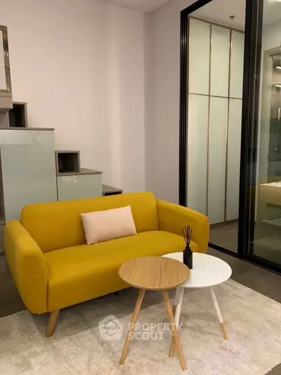 Stylish modern living room with yellow sofa and chic coffee tables