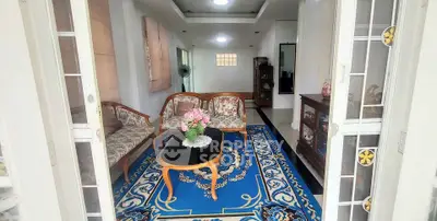 Charming living room with elegant furniture and vibrant blue carpet