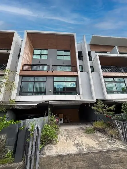 Modern multi-story townhouse with spacious balconies and sleek design.