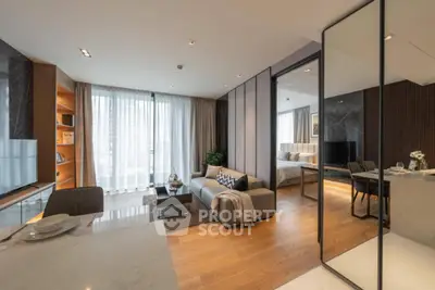 Modern open-plan living room with elegant decor and large windows in a luxury apartment.