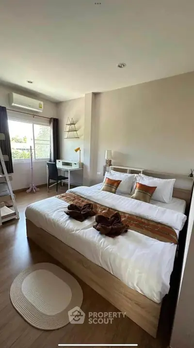 Cozy bedroom with modern decor and natural light in a stylish apartment