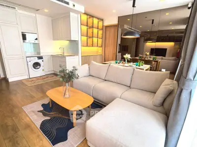 Modern open-plan living room with stylish kitchen and cozy seating area