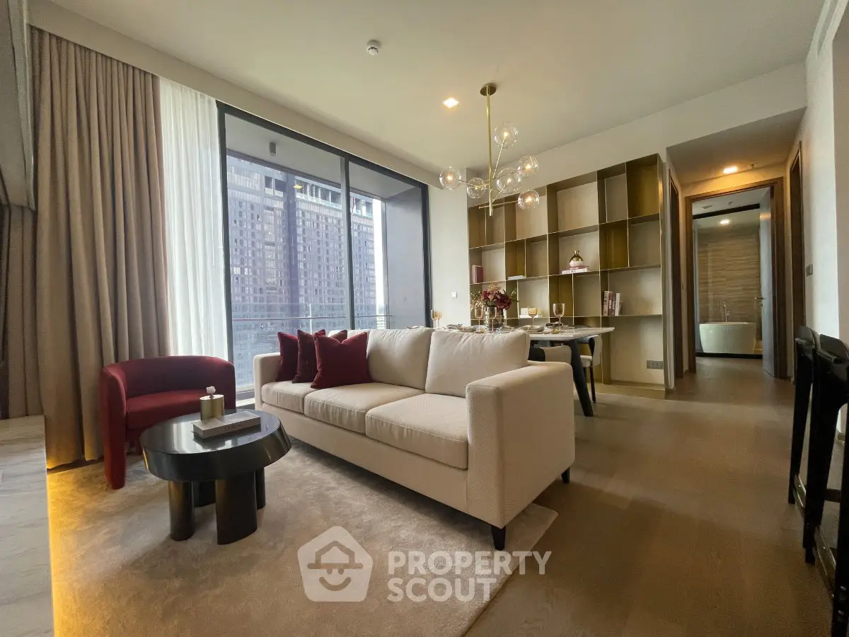 Modern living room with elegant decor and city view, featuring a cozy sofa and stylish dining area.