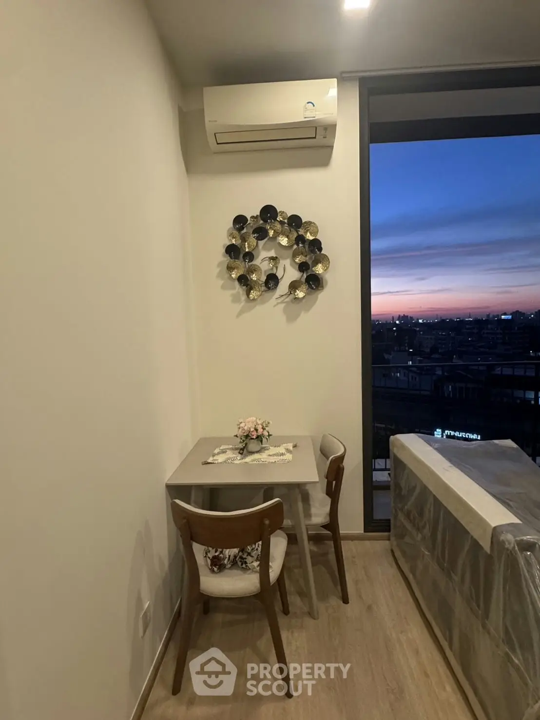 Cozy dining nook with modern decor and city view at sunset