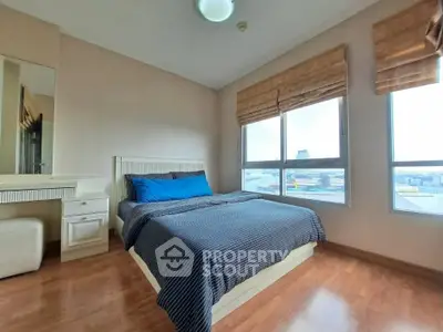 Spacious bedroom with city view and modern decor