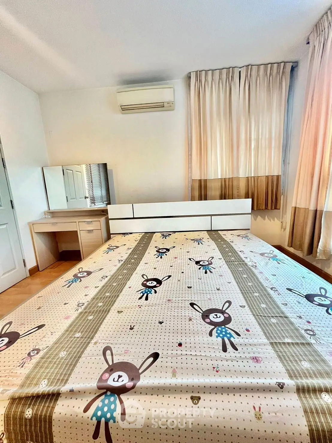 Charming bedroom with playful decor and ample natural light, perfect for cozy living.