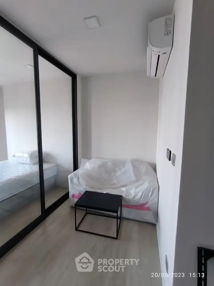 Modern bedroom with mirrored closet and air conditioning unit