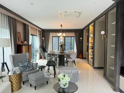 Luxurious living room with elegant decor, spacious seating, and modern lighting, perfect for relaxation and entertainment.