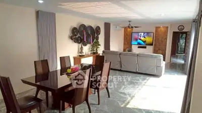 Spacious living and dining area with modern decor and ample natural light.
