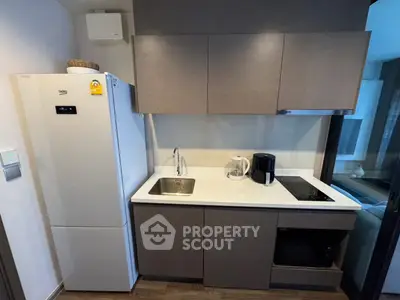 Modern compact kitchen with sleek cabinets and appliances