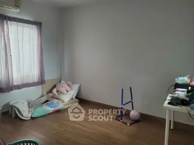 Minimalist bedroom with wooden flooring and simple decor, perfect for a cozy and personalized touch.