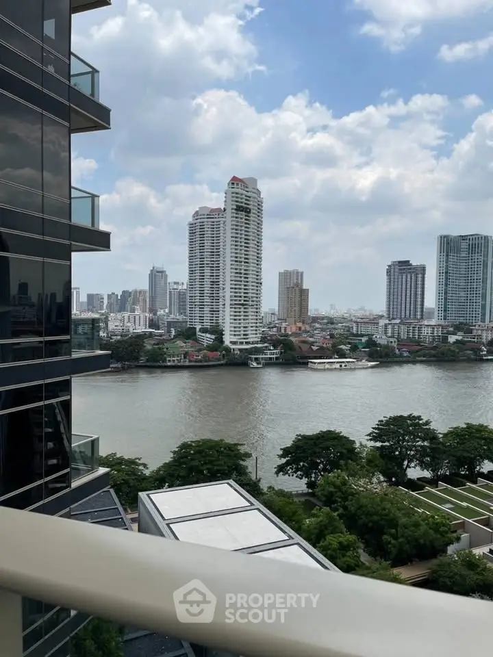 Stunning river view from a modern balcony in a high-rise building, showcasing city skyline and lush greenery.