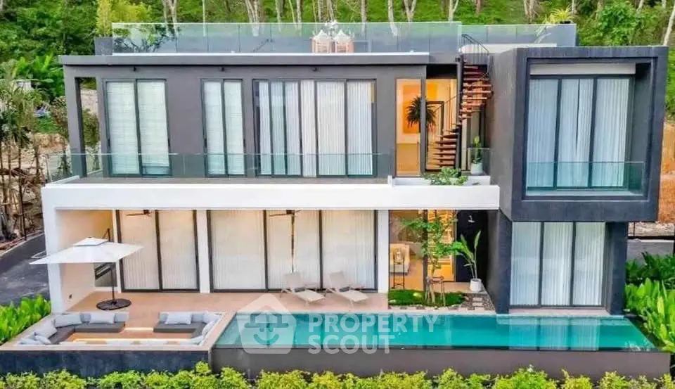 Luxurious modern villa with private pool and spacious balcony, surrounded by lush greenery.