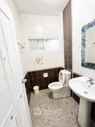 Cozy bathroom with modern fixtures and decorative tiles, perfect for a compact living space.