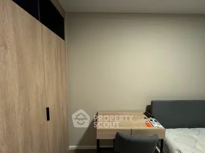 Modern bedroom with sleek wooden wardrobe and compact desk setup