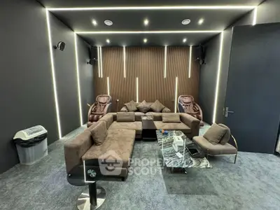 Luxurious home theater room with plush seating and modern lighting