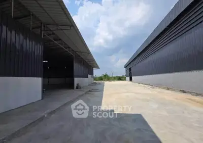 Spacious industrial warehouse exterior with ample outdoor space and modern design.