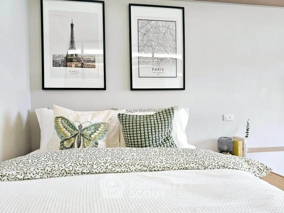 Chic bedroom with Paris-themed decor and cozy bedding