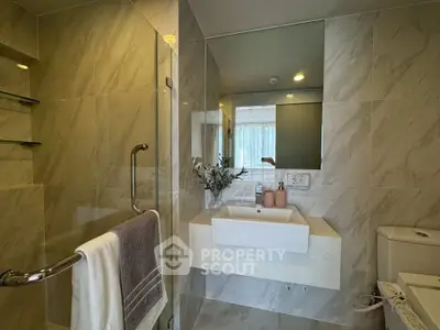 Modern bathroom with sleek design and elegant fixtures in a luxury apartment.