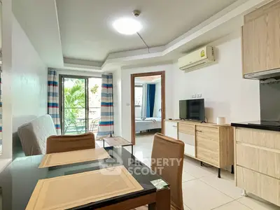 Modern open-plan living room with dining area and balcony view in a stylish apartment.