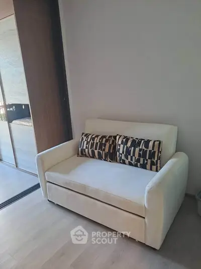 Cozy modern living room with stylish white sofa and decorative pillows