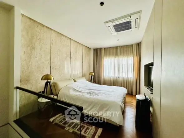 Modern bedroom with stylish decor and natural light