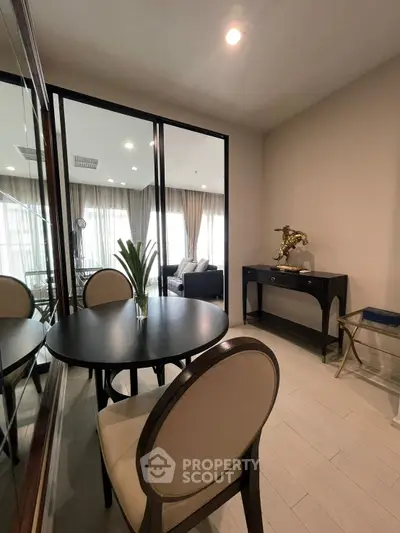 Elegant study room with stylish decor and glass partition leading to a cozy living area.