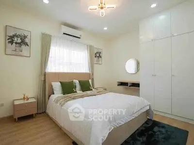 Cozy bedroom with modern decor, featuring a comfortable bed, stylish lighting, and ample storage space.