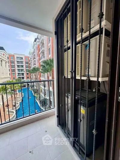 Charming balcony view overlooking a luxurious pool in a modern residential complex.