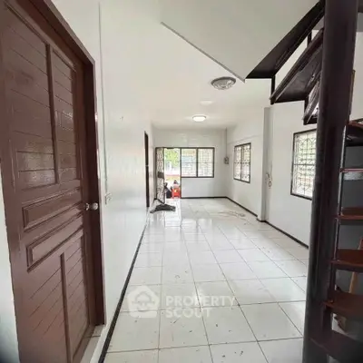 Spacious interior with tiled flooring and staircase, perfect for modern living.