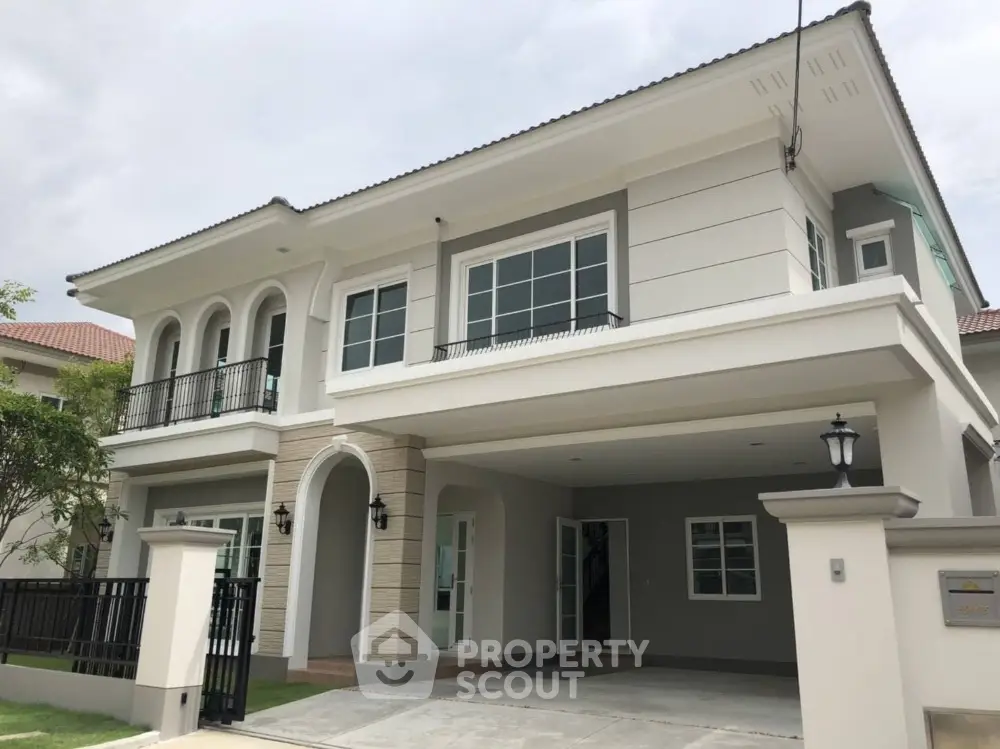 Modern two-story house with elegant facade and spacious driveway in a serene neighborhood.
