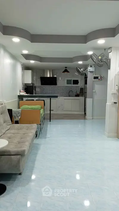 Spacious living room with modern kitchen and stylish decor