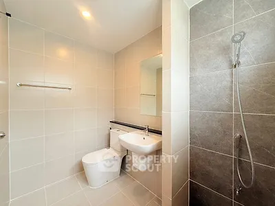 Modern bathroom with sleek fixtures and tiled walls