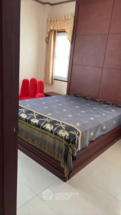 Cozy bedroom with elegant wooden paneling and stylish bedspread