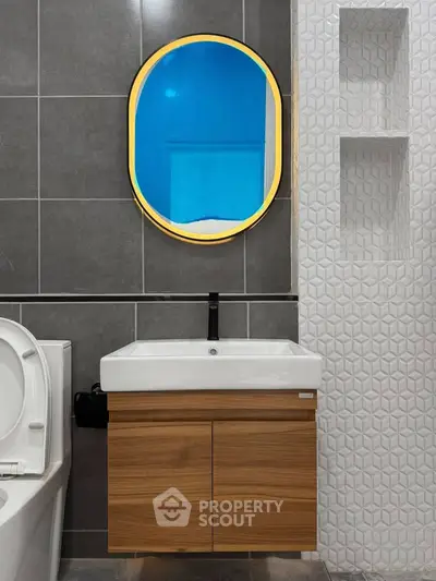 Modern bathroom with stylish mirror and elegant tile design