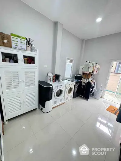 Spacious laundry room with modern appliances and ample storage space