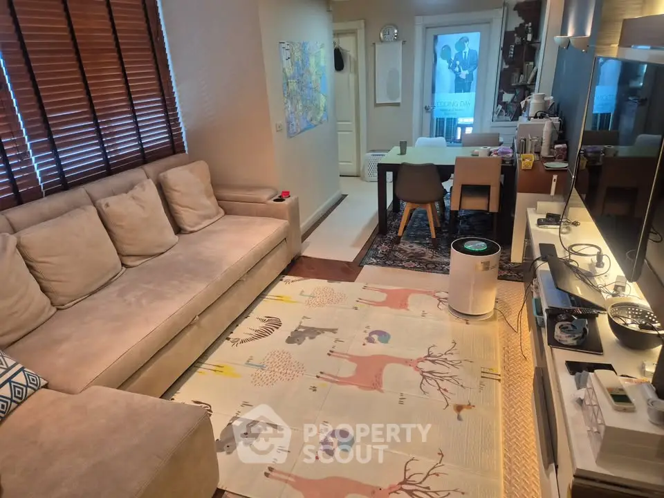 Cozy living room with modern decor and large sofa, perfect for relaxation.