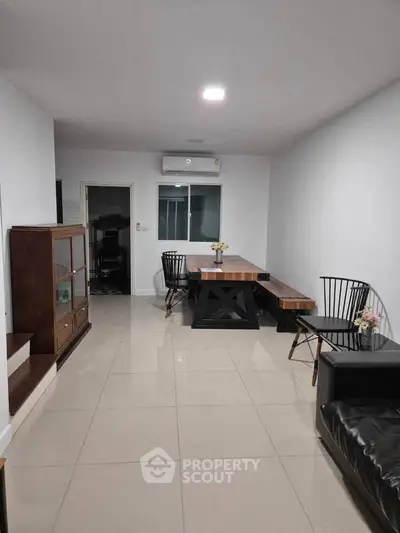 Spacious living room with modern furniture and sleek tile flooring