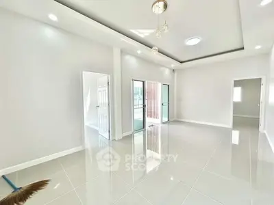 Spacious modern living room with glossy tile flooring and elegant lighting