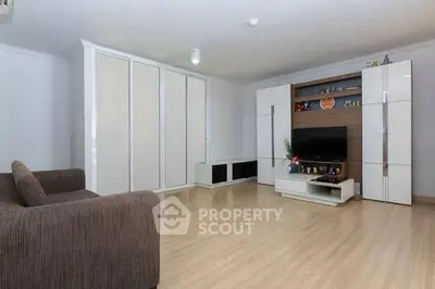 Spacious living room with modern furniture and ample storage space